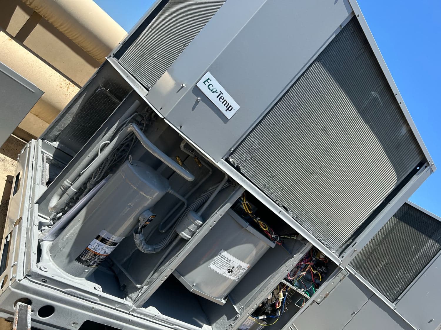 Packaged rooftop unit opened for a compressor replacement